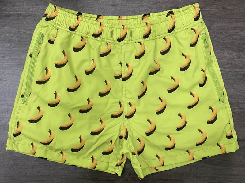 Back view of lime banana print swim shorts