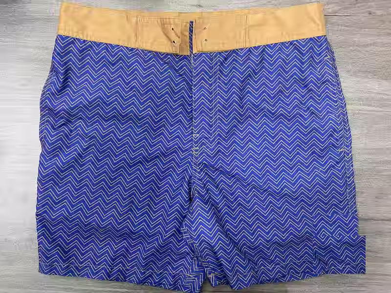 Front view of blue chevron fixed-waist board shorts