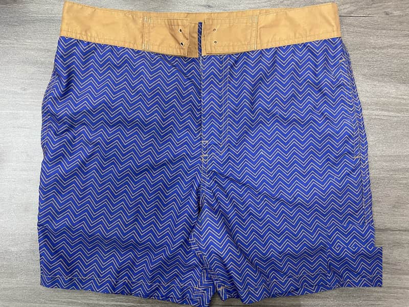Front view of self-owned blue chevron fixed-waist board shorts