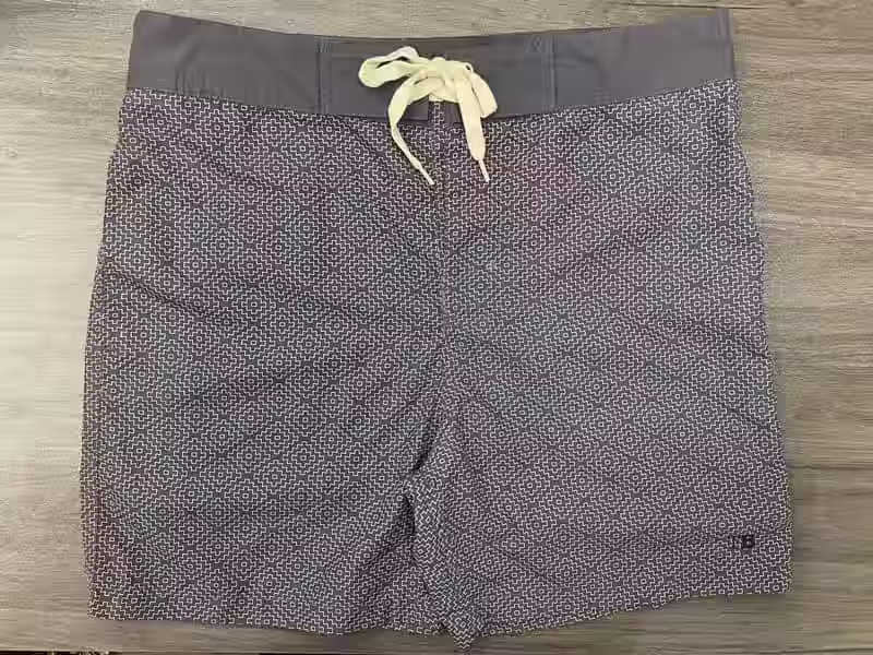 Front view of charcoal micro-geometric fixed-waist board shorts