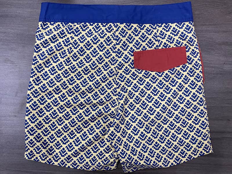 Back view of cobalt geometric board shorts with contrast pocket