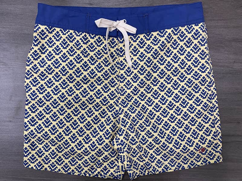 Front view of self-owned cobalt geometric fixed-waist board shorts