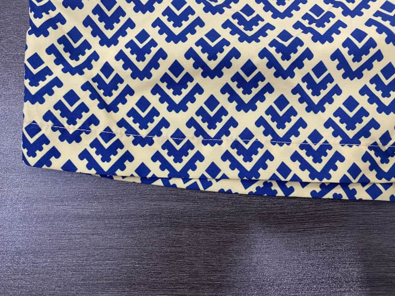 Hem and cobalt repeat detail on fixed-waist board shorts