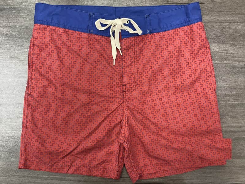 Front view of self-owned coral micro-geometric fixed-waist board shorts