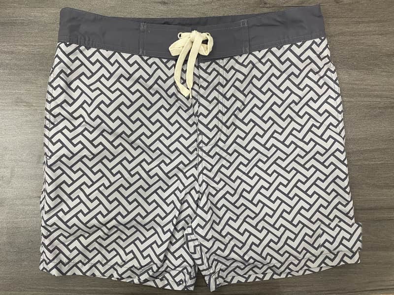 Front view of self-owned fixed-waist board shorts with black and white maze print