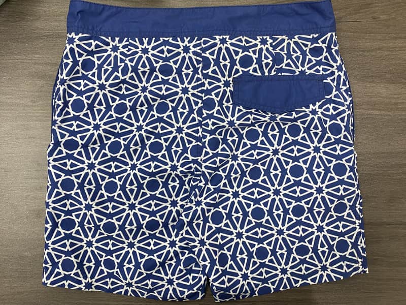 Back pocket and large repeat detail on navy abstract board shorts