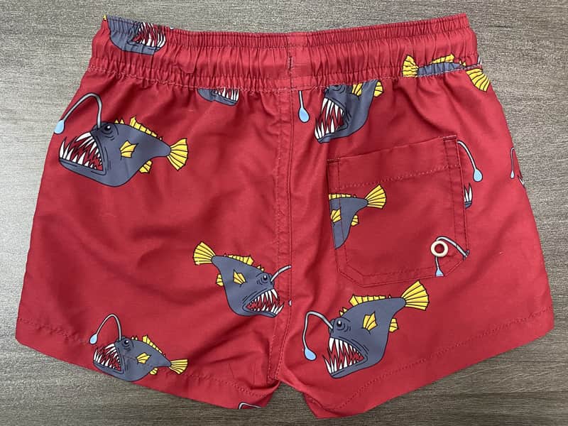 Back view of red fish print swim shorts