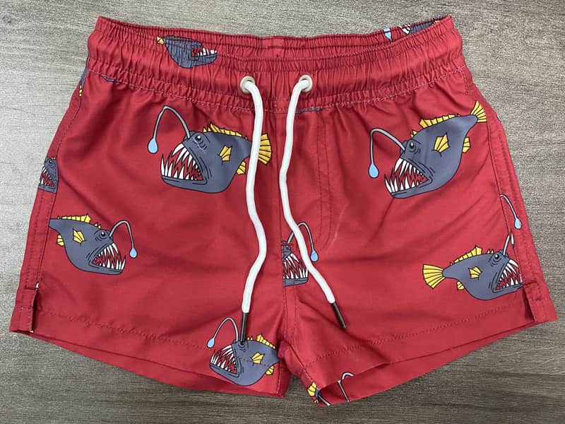 Front view of self-owned red elastic-waist swim shorts with large fish print