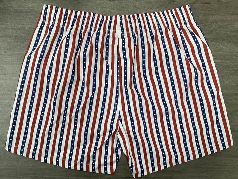 Back view of red navy and white striped swim shorts