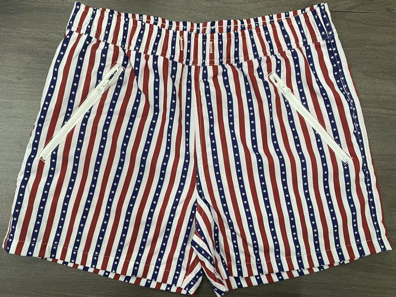 Front view of self-owned red navy and white striped elastic-waist swim shorts