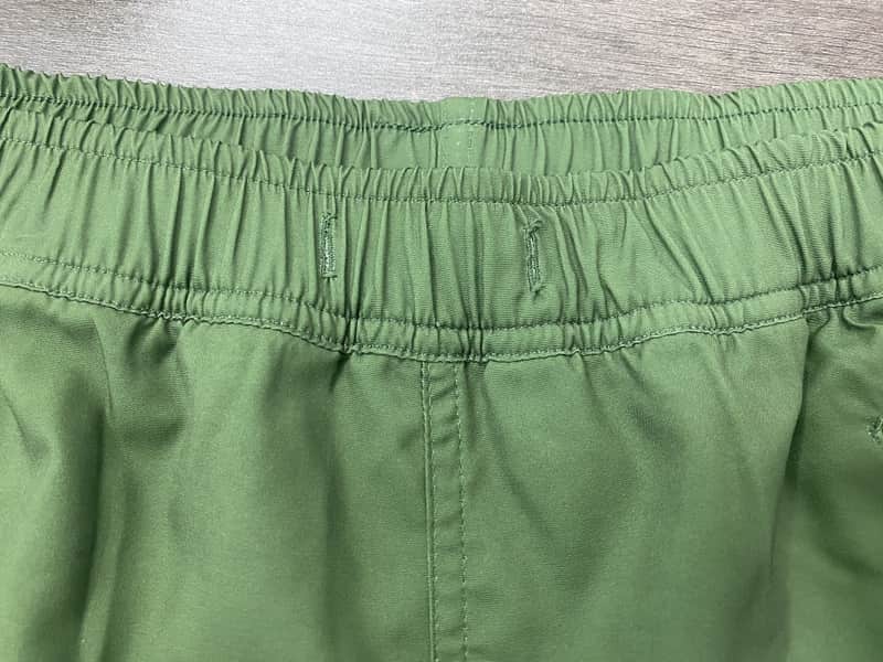 Elastic waistband construction detail on sage solid swim shorts