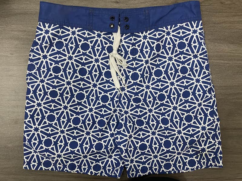 Back pocket and horizontal print placement detail on sand geometric swim shorts