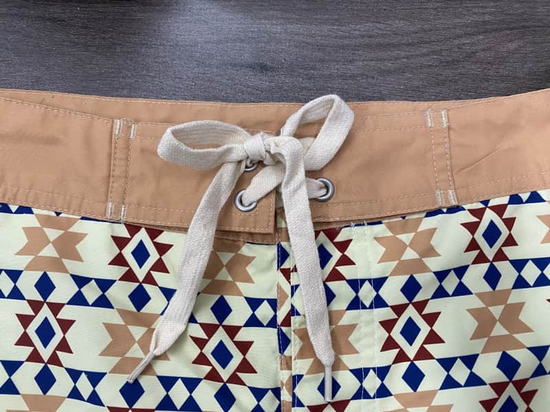Contrast waistband and drawcord detail on sand geometric swim shorts
