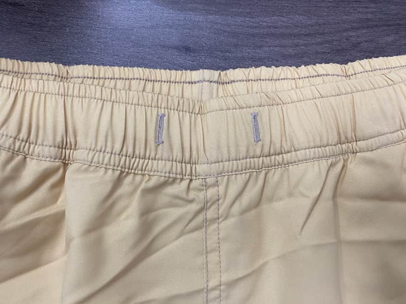 Back waistband detail on sand solid swim shorts